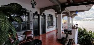 a living room with a view of the water at Mikaso Hotel in San Pedro La Laguna