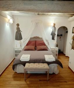 a bedroom with a large bed with a canopy at Livia's Charming Room in Trevignano Romano