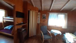 a bedroom with a bunk bed and a desk and a chair at 2 Bursztyny in Rusinowo