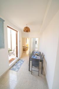 a dining room with a table and chairs at VICOLO A MARE in Siracusa +25 photos