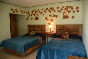Postel nebo postele na pokoji v ubytování HOTEL CASA LIMON