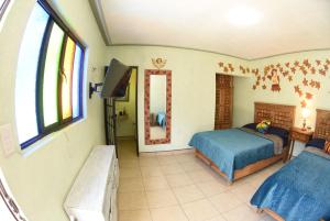 Voodi või voodid majutusasutuse HOTEL CASA LIMON toas