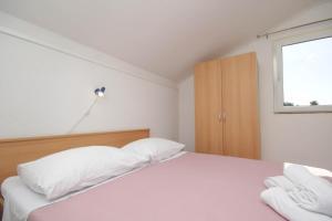 Postel nebo postele na pokoji v ubytování Apartmani Horvat