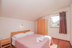 Postel nebo postele na pokoji v ubytování Apartmani Horvat