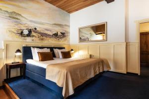 Un pat sau paturi într-o cameră la Hotel de Watermölle