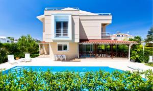 a villa with a swimming pool and a house at Paradise Town Villa Premium 100 MBPS free wifi in Belek