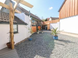 a courtyard with potted plants and a house at Toadstools in Penryn