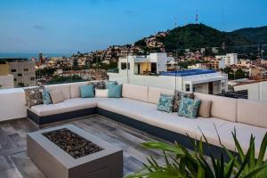 a white couch sitting on top of a roof at Condominio Loft 268 Zona Romántica Departamento 510 in Puerto Vallarta