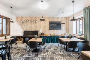 a dining room with tables and a piano at Penzion Dubina in Litoměřice