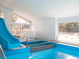 a swimming pool in a house with a slide at Four-Bedroom Holiday home in Fjerritslev 3 in Torup Strand