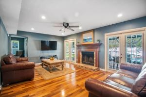 a living room with a couch and a fireplace at Tampa Bay Pool Home with Heated Pool in Brandon