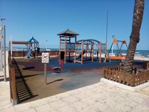 an empty playground at the beach with a play structure at Apartamentos playa de Bellreguard in Bellreguart