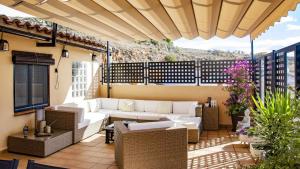 d'une terrasse avec un canapé et des chaises sur un balcon. dans l'établissement Atico con vistas en Albentosa La Torre, à Albentosa