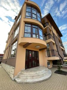 a large building with stairs in front of it at Vila Puky in Neptun