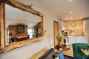 a mirror on the wall of a kitchen with a table at Beach View in Benllech