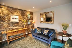 a living room with a couch and a mirror at Beach View in Benllech