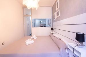 A bed or beds in a room at LE NOTTI GEMELLE
