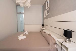 A bed or beds in a room at LE NOTTI GEMELLE