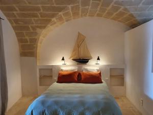 1 dormitorio con 1 cama con un velero en la pared en Les Canisses, magnifique appartement avec terrasse au cœur d'Uzès, en Uzès