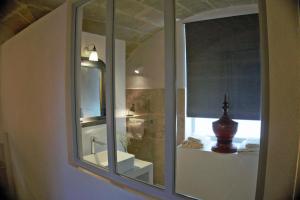 a bathroom with a mirror and a sink at Les Canisses, magnifique appartement avec terrasse au cœur d'Uzès in Uzès