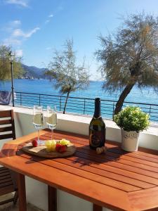 a table with a bottle of wine and two glasses at Mori's Beautiful Sea front Apartment - With A.C. in Monterosso al Mare