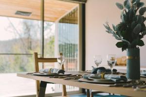 una mesa con gafas y un jarrón con una planta. en Blue Spring Villa - Vacation STAY 11143, en Kado