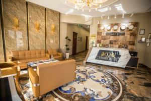 a lobby with couches and a table in a room at Leader Hotel in Tashkent