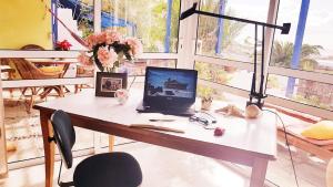 A television and/or entertainment centre at Holidays in Tarajalejo - home office with sea view