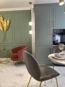 a living room with a chair and a table at Marble Apartments 2 in Oradea +19 photos