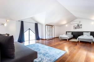 a living room with a couch and a table at Baia da Luz - Poolview Loft Aparment in Luz +20 photos