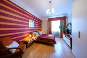 a bedroom with a large bed and a large window at Boutique Apart-Hotel Sherborne in Kyiv