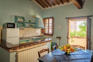 a kitchen with a table and a counter top at Country House Podere Lacaioli in Castiglione del Lago