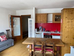 a kitchen with a wooden table in a room at Résidence au coeur d'Argentière in Chamonix-Mont-Blanc