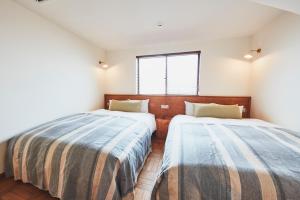 Uma cama ou camas num quarto em THE FLOW KAMAKURA