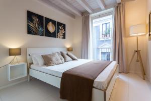 a bedroom with a large bed and a window at Stesicoro Exclusive House in Catania