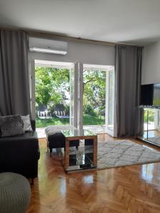 a living room with a couch and a glass table at Villa deluxe "H" - private jacuzzi in Novi Vinodolski