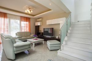 sala de estar con escalera, sofá y TV en EVA's House en Pastida