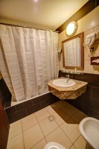 a bathroom with a sink and a mirror and a toilet at Crystal Hotel By FHM in Aqaba +48 photos