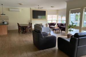 a living room with couches and a dining room at Victoria House- Great location in Corowa