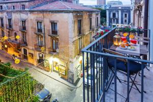 a balcony with christmas decorations on a city street at Stesicoro Exclusive House in Catania