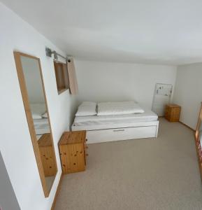 a small room with a bed and a mirror at Résidence au coeur d'Argentière in Chamonix-Mont-Blanc