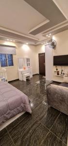 a bedroom with a bed and a living room at Al Moltaqua Chalet in Taif