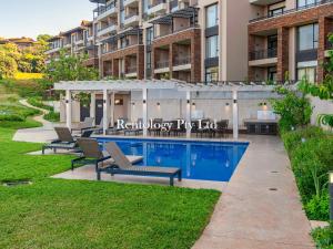a swimming pool in the backyard of a building at Grandoise 2 Bed Zimbali Suites in Ballito
