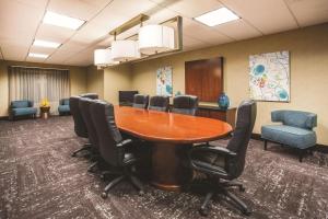 a conference room with a wooden table and chairs at La Quinta by Wyndham Ely in Ely
