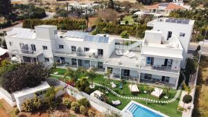 an aerial view of a large white house with a swimming pool at Silver Sea Holiday Apartments in Ayia Napa