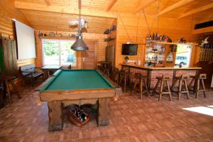 a pool table in a room with a bar at Messe-Hotel "Waldruhe" in Giesen