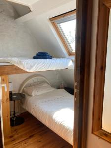 a bedroom with two bunk beds in a attic at The Bakery in Beauficel