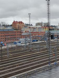 a group of train tracks in a city with buildings at Vaunukatu in Turku