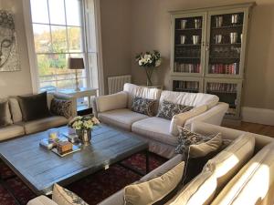 a living room with couches and a coffee table at 1 Georges Place Bath in Bath