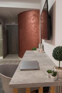 a laptop sitting on a counter in a kitchen at Vanilla Boutique Apartments in Skopje